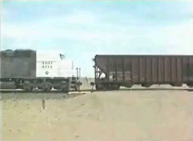 Locomotive approaching hopper cars.